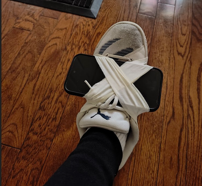 A phone taped to a shoe
