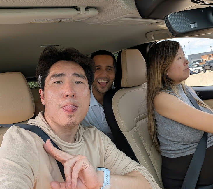 The team on a road trip, making faces at the camera